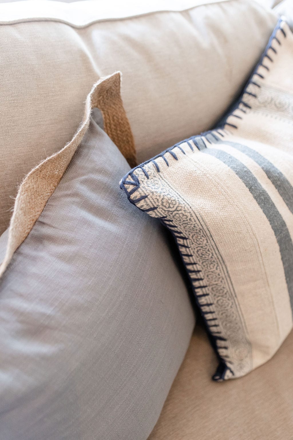 Inexpensive throw pillows. Decorating without spending too much money on home decor accents in blue and light brown colors.