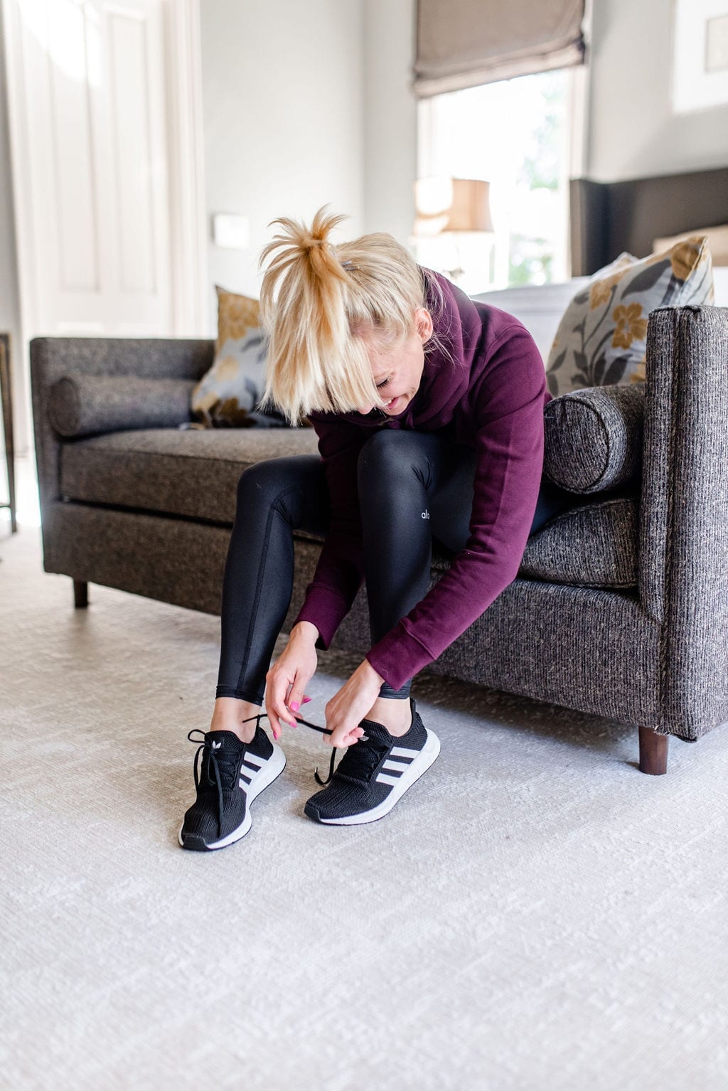 Black Adidas shoes for women. Black running shoes with white stripes.