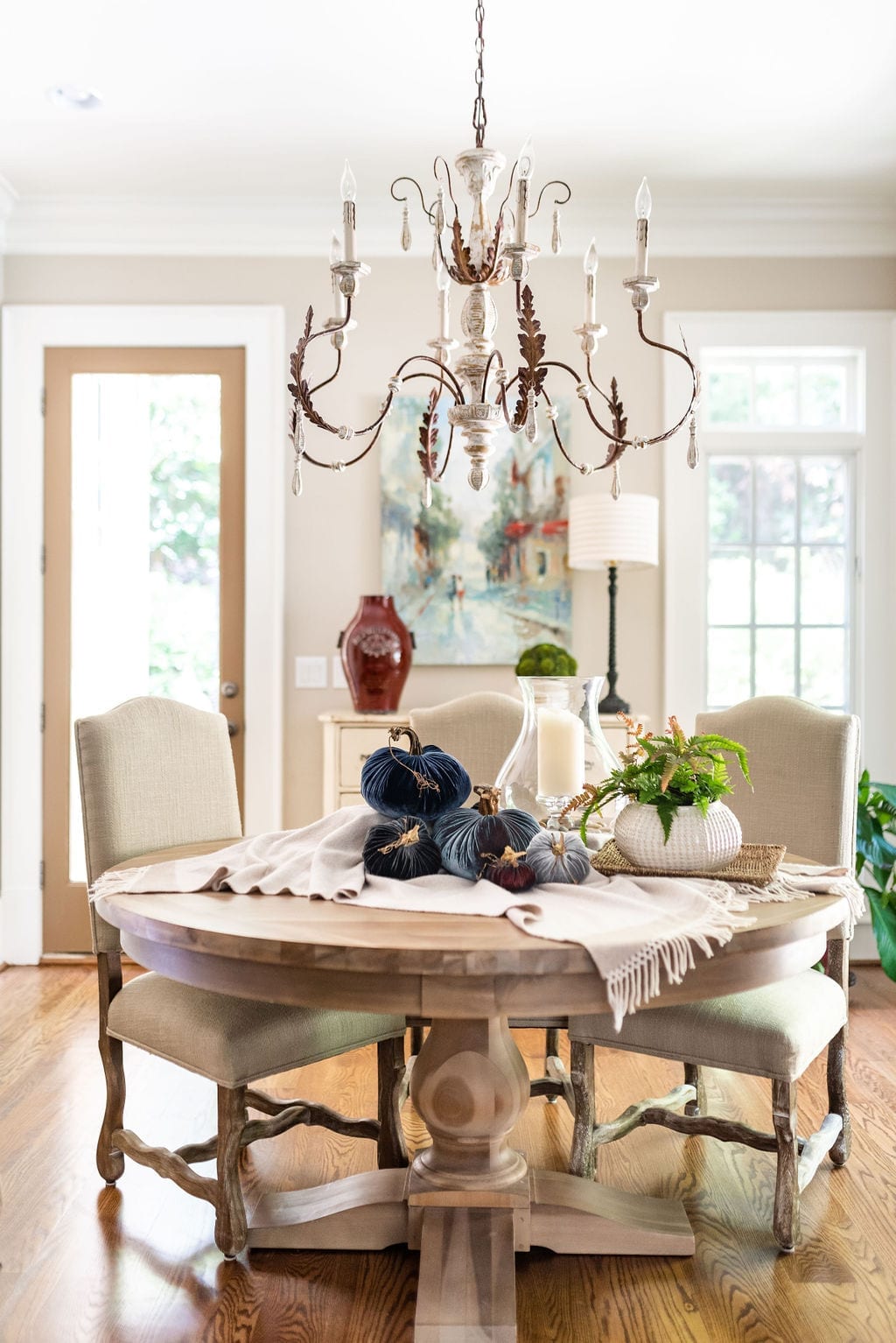 Easy Thanksgiving Centerpiece with round wood dining room table and light wood chairs.