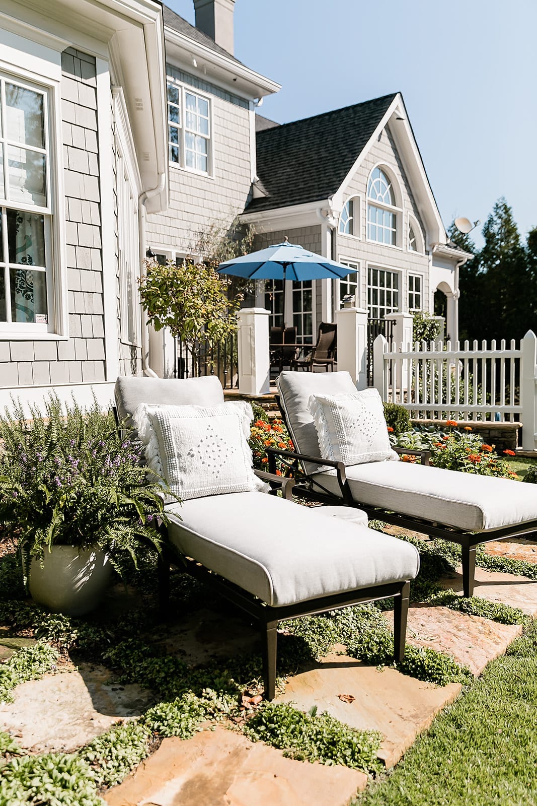 Fern Container Planter and Woodard Chaise Lounges. Stone and maizes ground cover for summer planting inspiration.