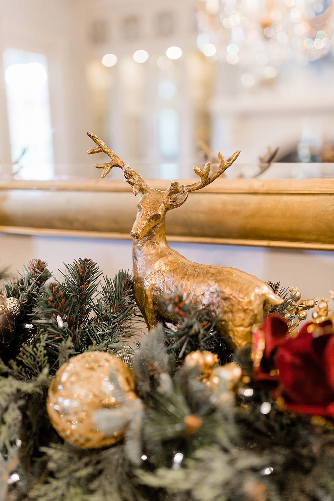Use gold and dark red for buffet decorations for dining room Christmas decor. Accents of Christmas reindeer and deep colors.