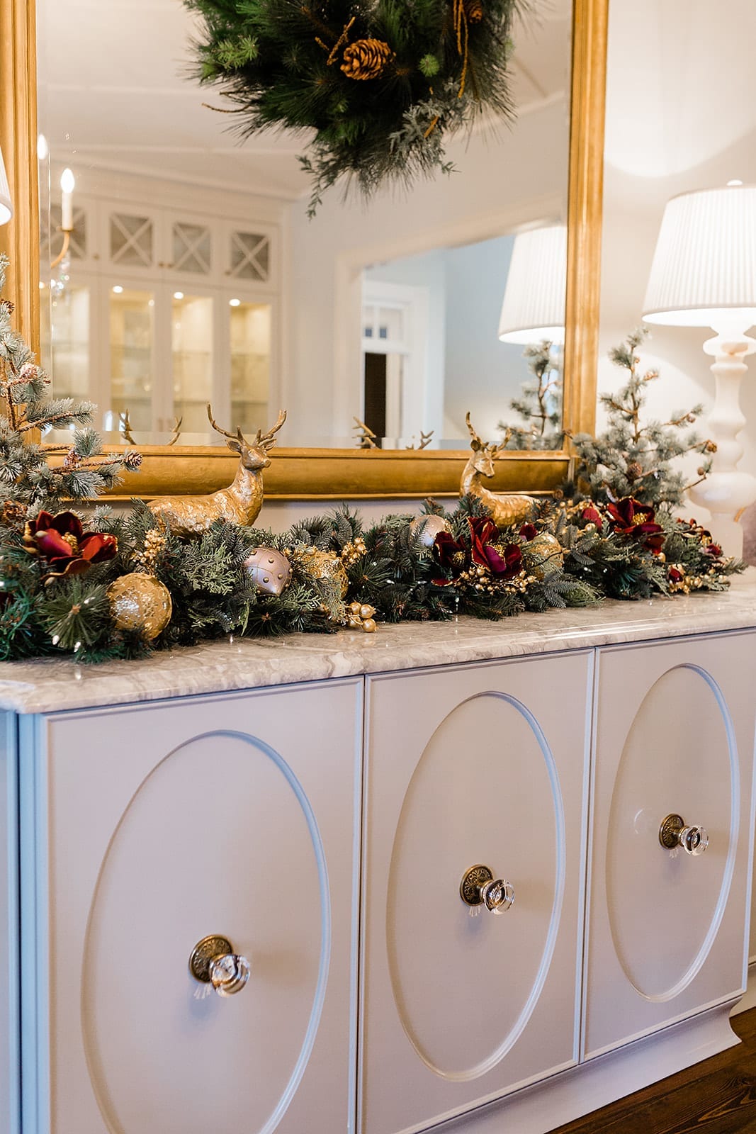 Magnolia garland for Christmas with reindeer decorations for christmas and faux flocked Christmas trees.