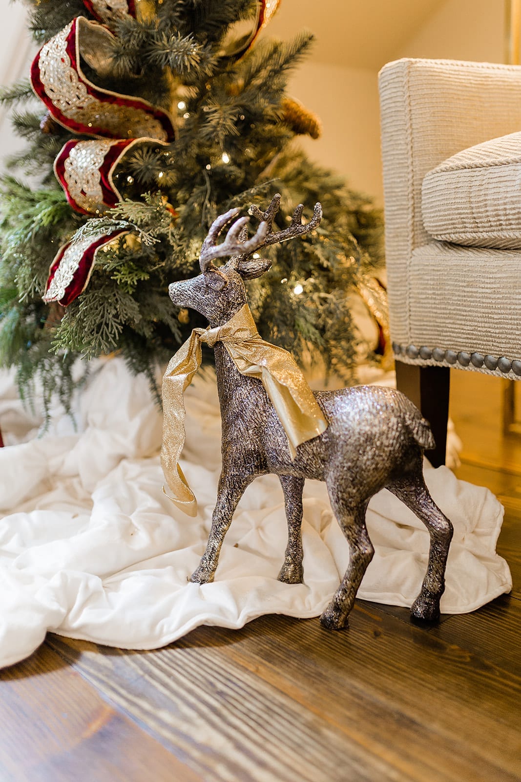 Gold Reindeer with miniature Christmas tree for foyer Christmas decor ideas.
