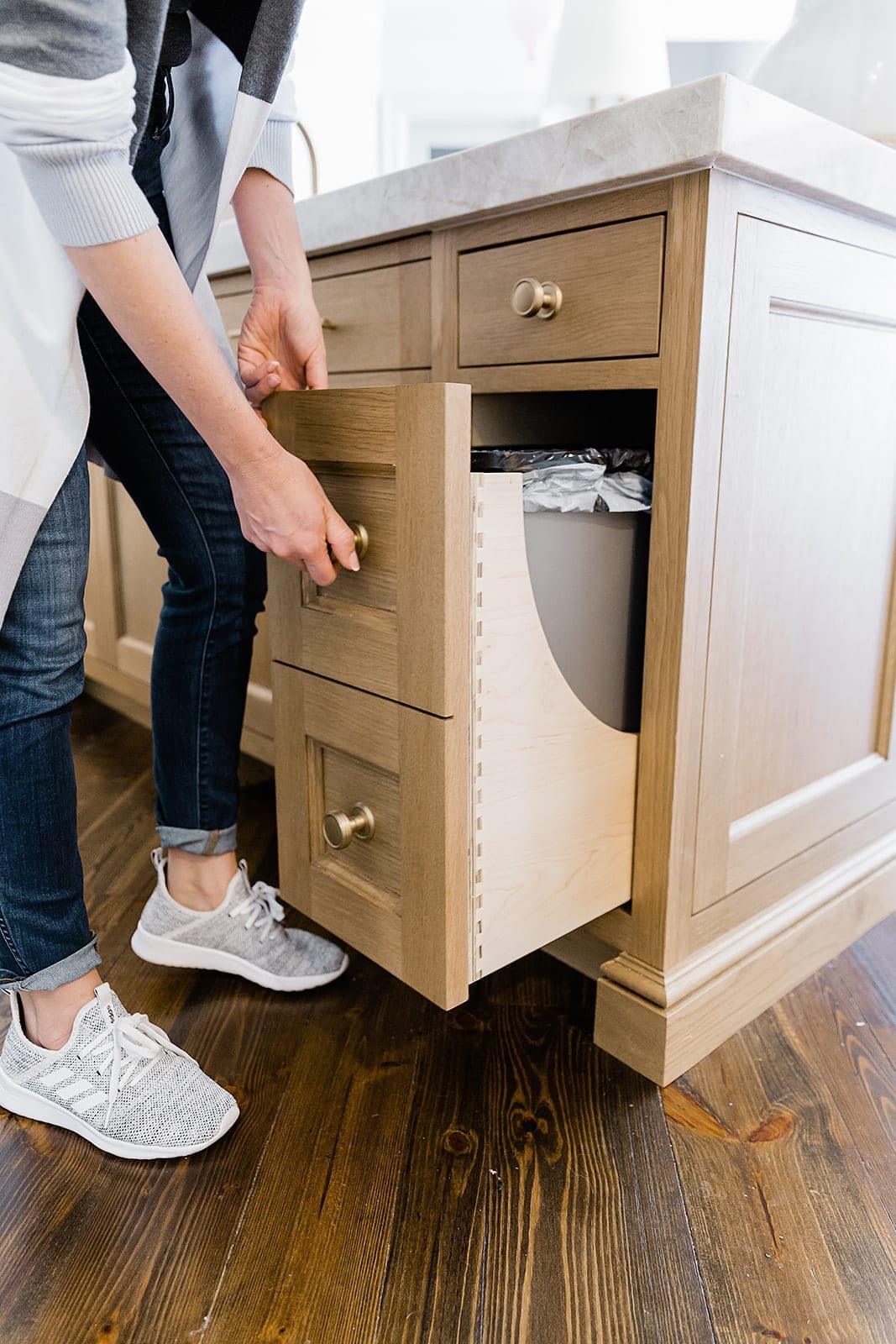 Kitchen cabinet hardware ideas. Built in trash can in oak kitchen island.