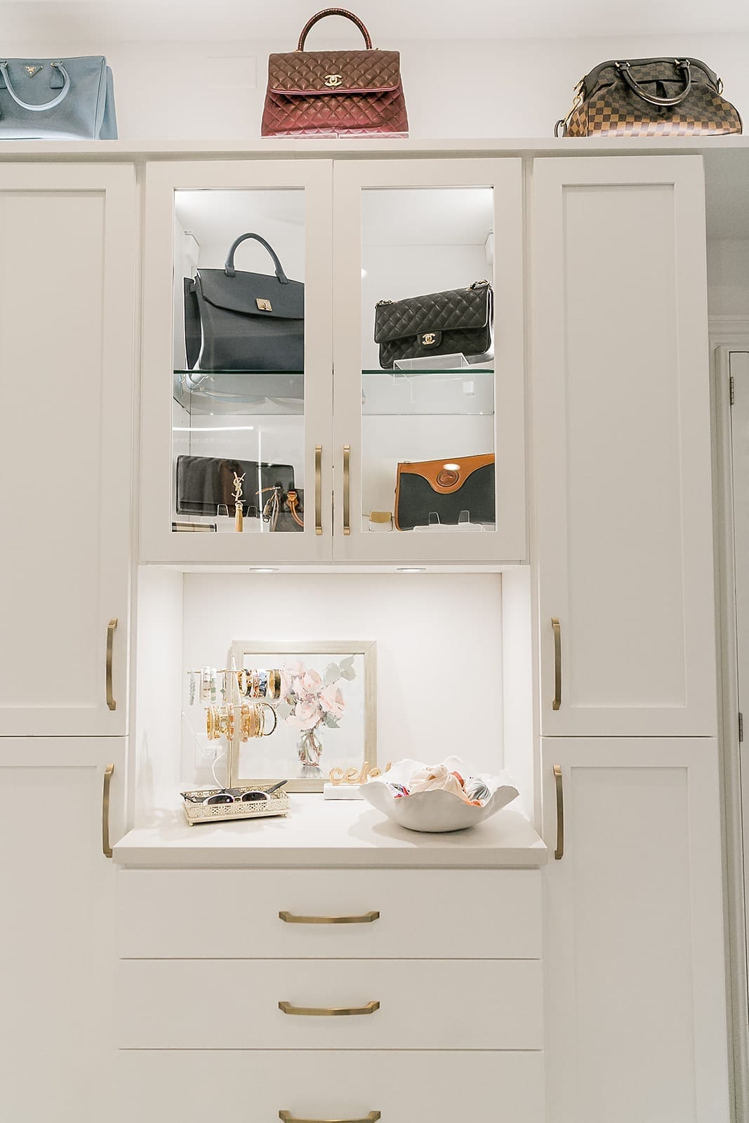 How to display handbags. Designer closet with handbag display behind glass shelves. Display jewelry with scarf storage.