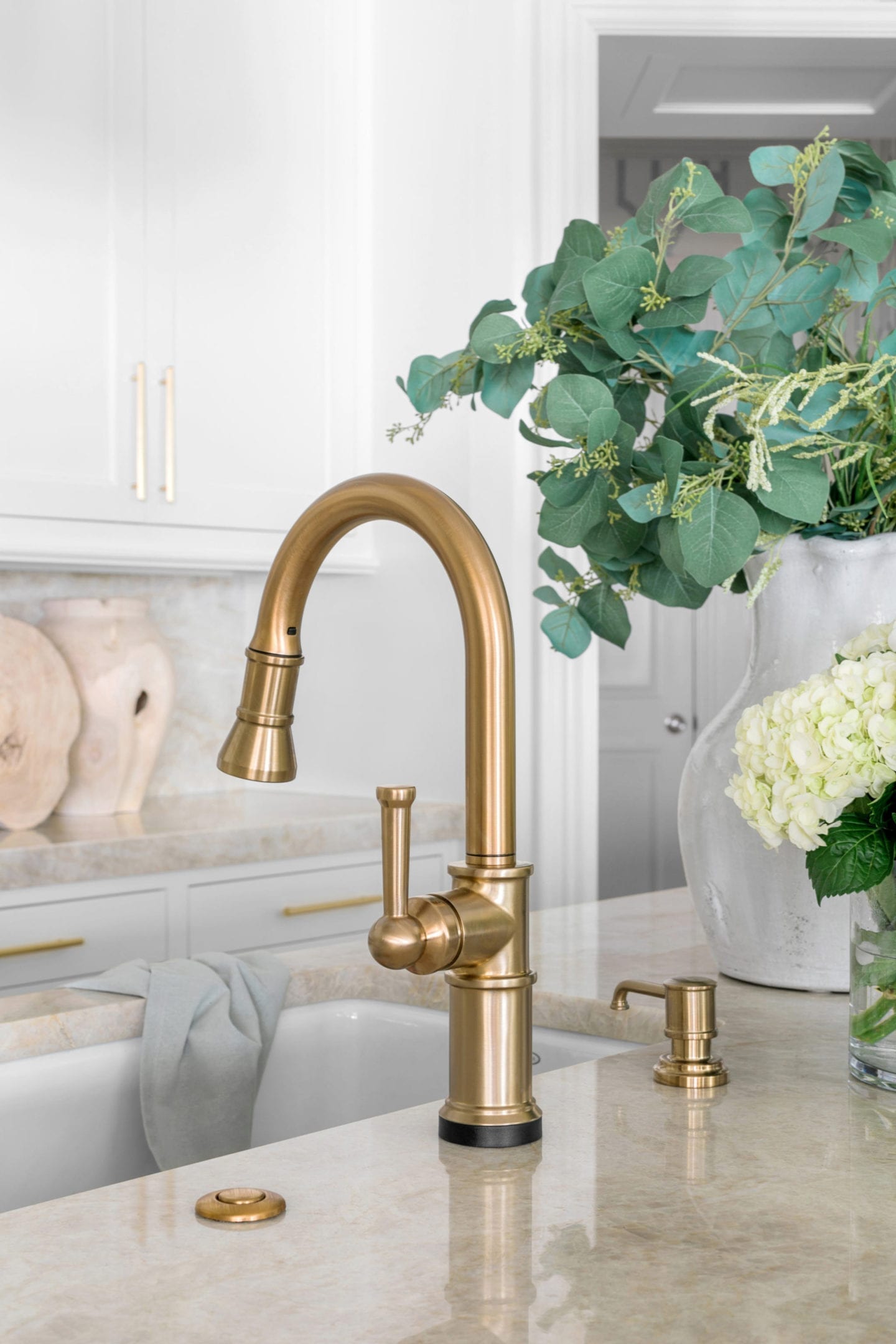 Briza Sink Faucet - a touchless faucet in white and blue kitchen.