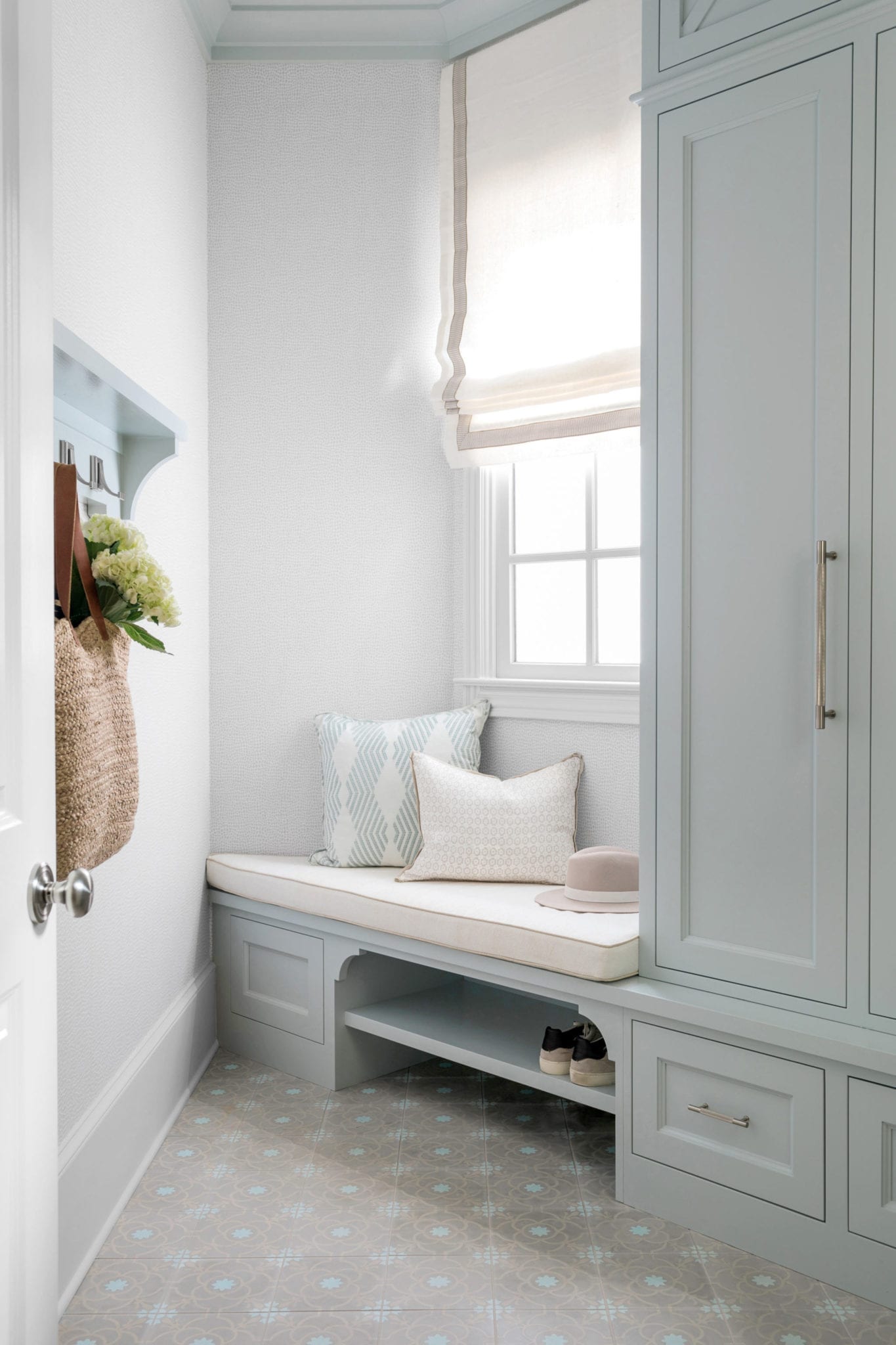 Mudroom Built In Cabinet Ideas with built in shoe storage, mudroom bench, blue cabinets and window covered in roman shade.