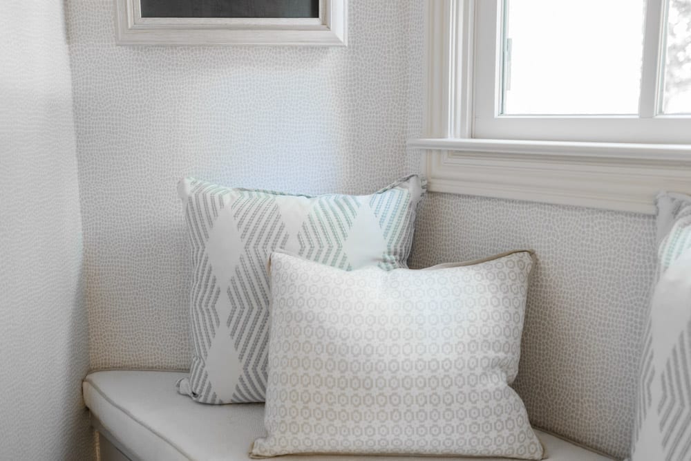 Mudroom organizing ideas. See our mudroom locker cubbies with doors, mudroom bench seat, roman shade and throw pillows all decorated with blue cabinetry, silver lantern pendant and patterned clement tile floor.
