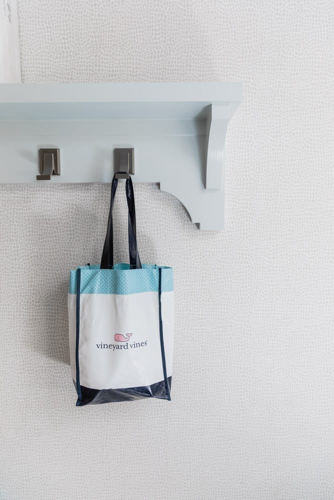 Mudroom organizing ideas. See our mudroom locker cubbies with doors, mudroom bench seat, roman shade and throw pillows all decorated with blue cabinetry, silver lantern pendant and patterned clement tile floor.