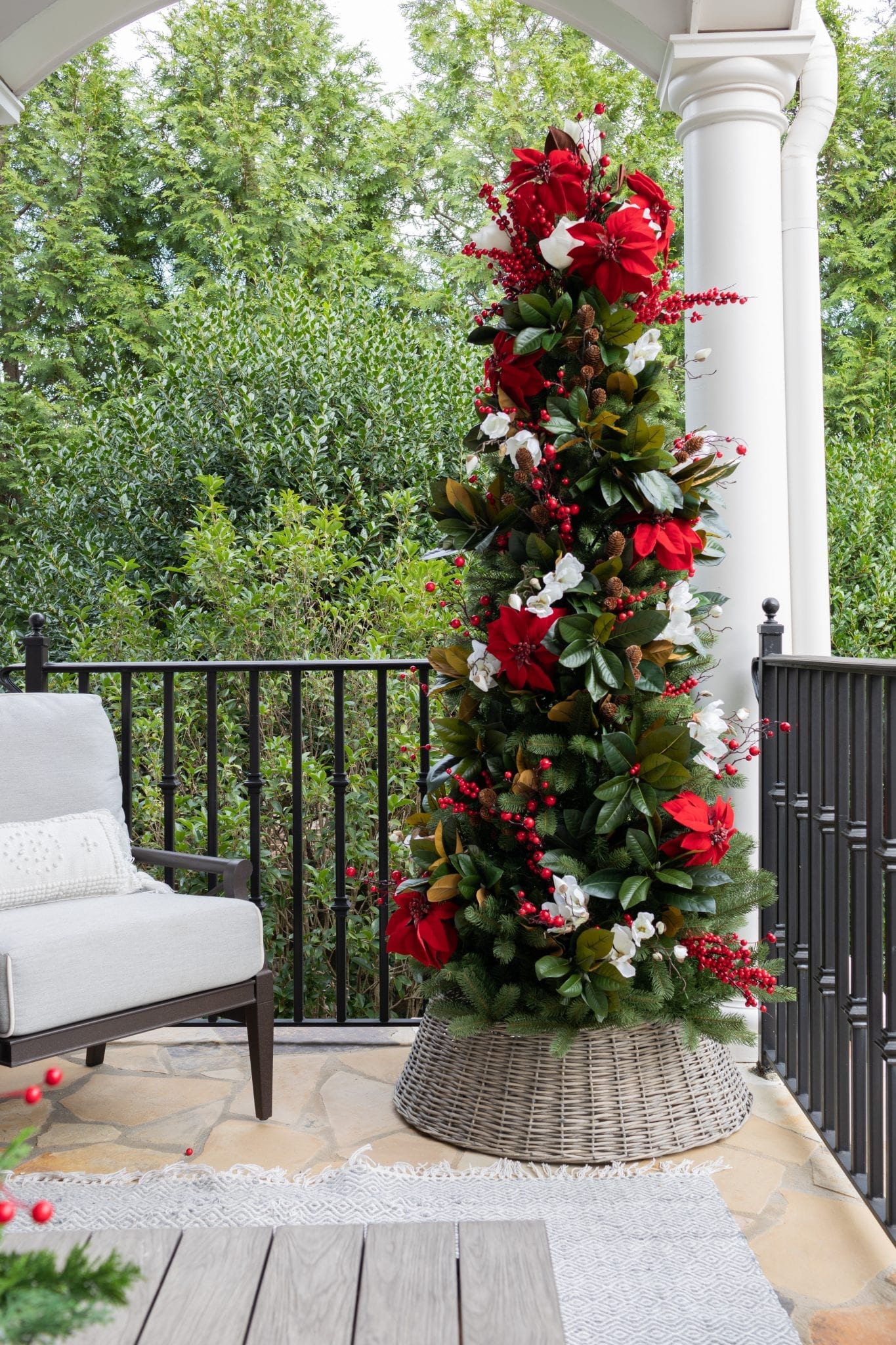 Magnolia Christmas tree full of red poinsettia christmas tree decorations and magnolia Christmas decorations.