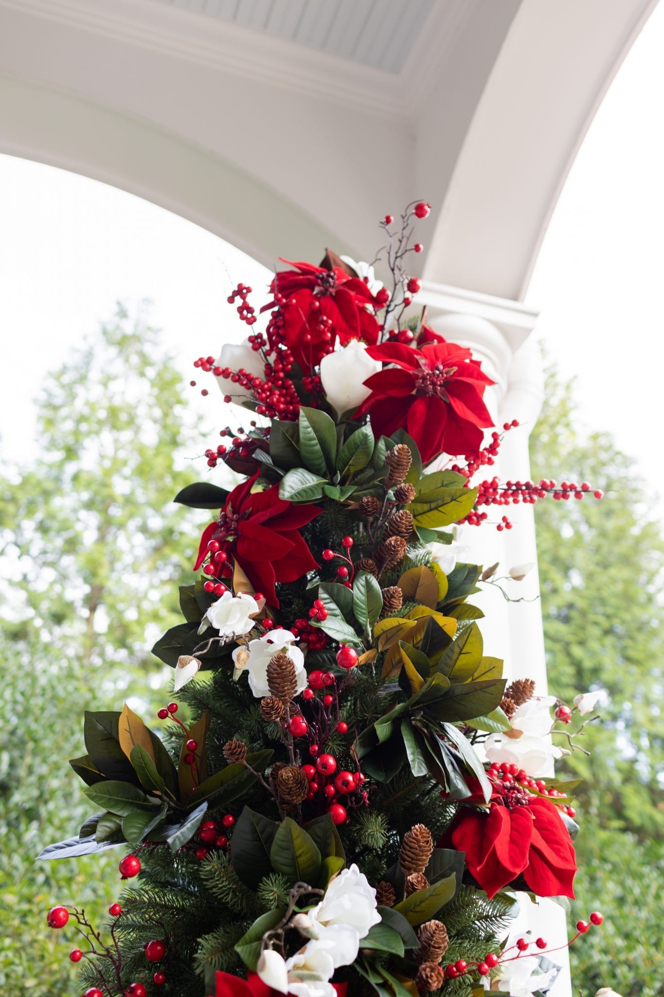 To create a simply southern Christmas, you need basic ingredients: magnolia, poinsettia & a bit of the outdoors! This magnolia tree is beautiful both inside or for balcony christmas decorations! If you need Christmas balcony ideas, this tree along with artificial poinsettia plants for outside may be just the ticket!