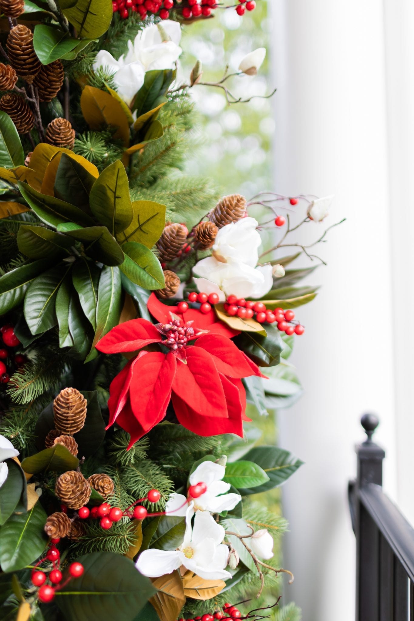 To create a simply southern Christmas, you need basic ingredients: magnolia, poinsettia & a bit of the outdoors! This magnolia tree is beautiful both inside or for balcony christmas decorations! If you need Christmas balcony ideas, this tree along with artificial poinsettia plants for outside may be just the ticket!