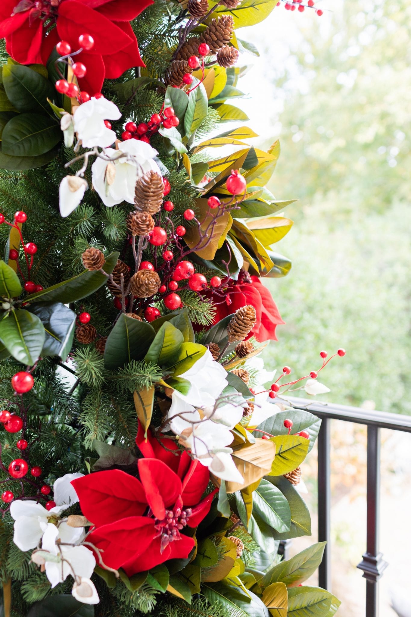 To create a simply southern Christmas, you need basic ingredients: magnolia, poinsettia & a bit of the outdoors! This magnolia tree is beautiful both inside or for balcony christmas decorations! If you need Christmas balcony ideas, this tree along with artificial poinsettia plants for outside may be just the ticket!