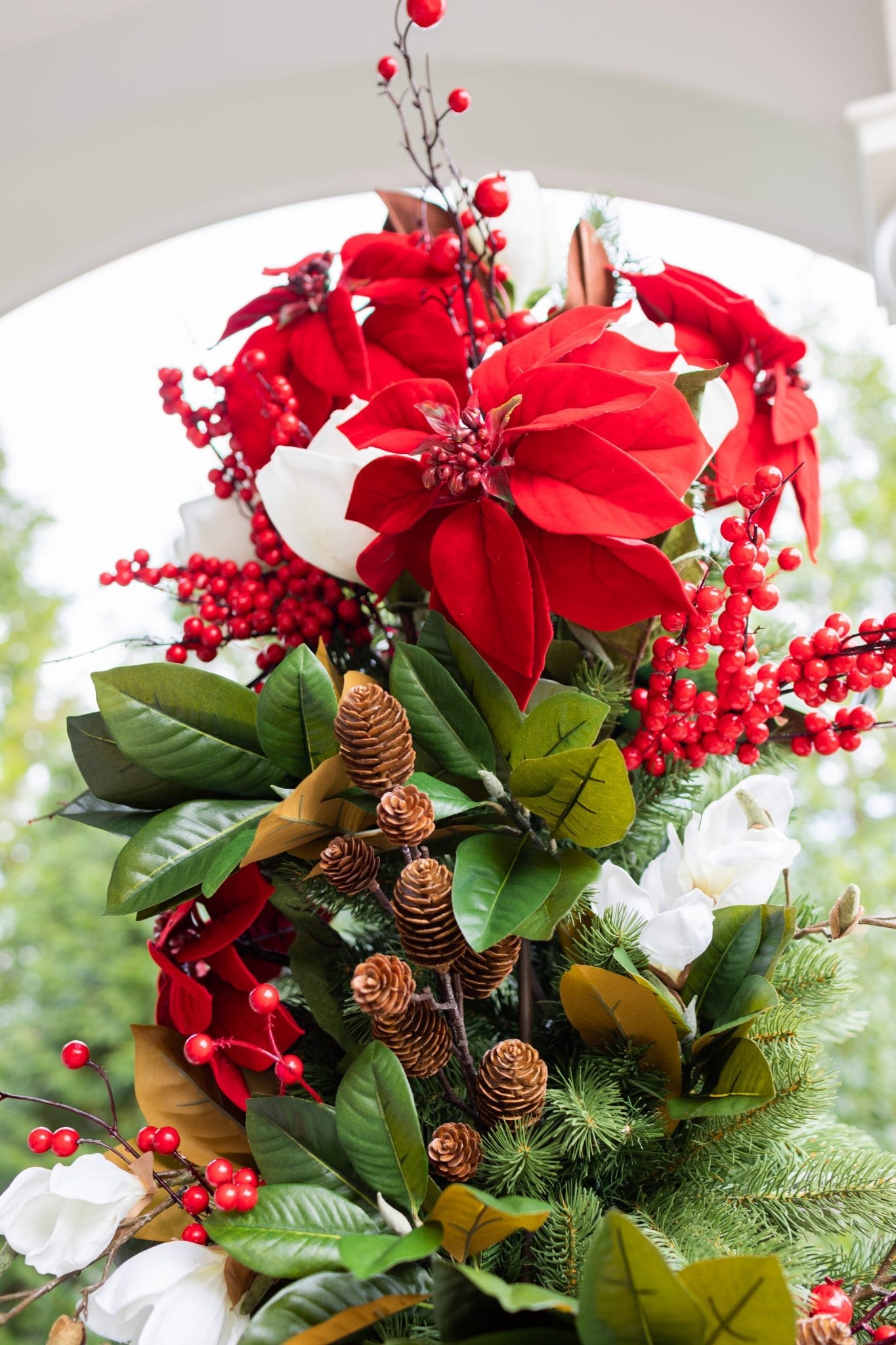 To create a simply southern Christmas, you need basic ingredients: magnolia, poinsettia & a bit of the outdoors! This magnolia tree is beautiful both inside or for balcony christmas decorations! If you need Christmas balcony ideas, this tree along with artificial poinsettia plants for outside may be just the ticket!