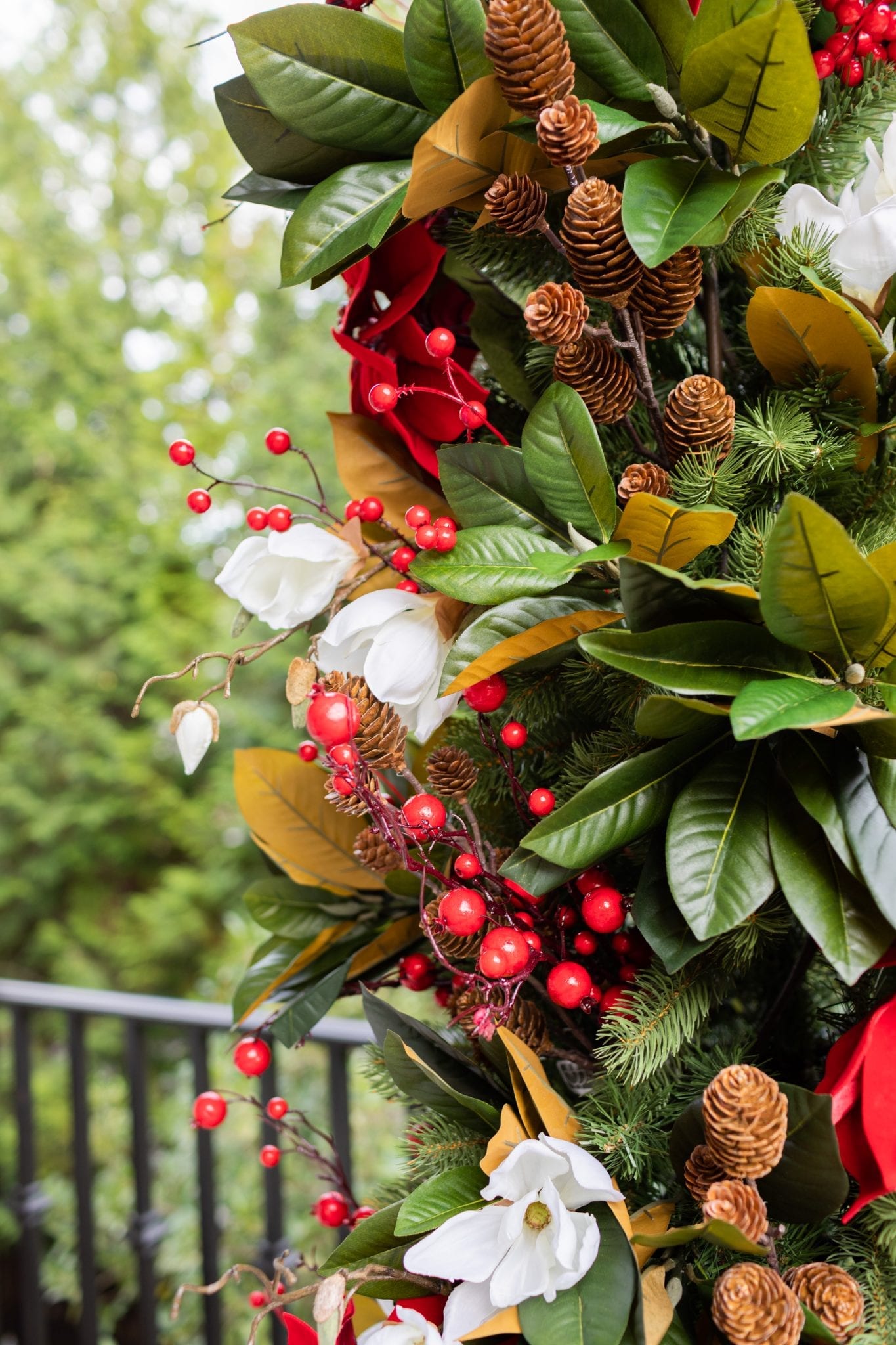 To create a simply southern Christmas, you need basic ingredients: magnolia, poinsettia & a bit of the outdoors! This magnolia tree is beautiful both inside or for balcony christmas decorations! If you need Christmas balcony ideas, this tree along with artificial poinsettia plants for outside may be just the ticket!