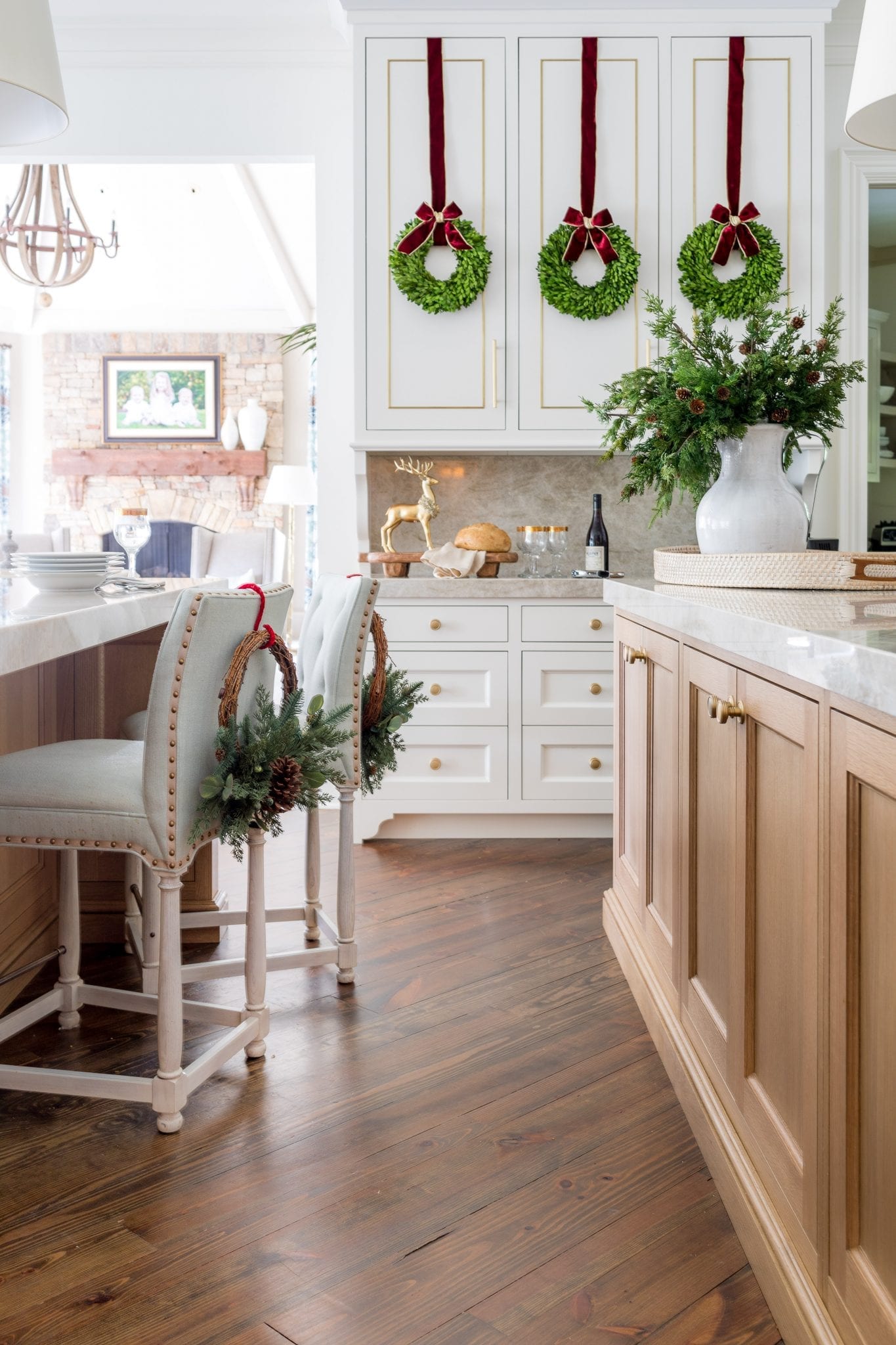 Mini wreaths for cabinets in Christmas themed kitchen. A mini Christmas wreath can add that flare of cheer without overdoing or overwhelming your cabinet space. If a   mini is too tiny, upgrade to a small Christmas wreath. These wreaths are mini boxwood wreath.