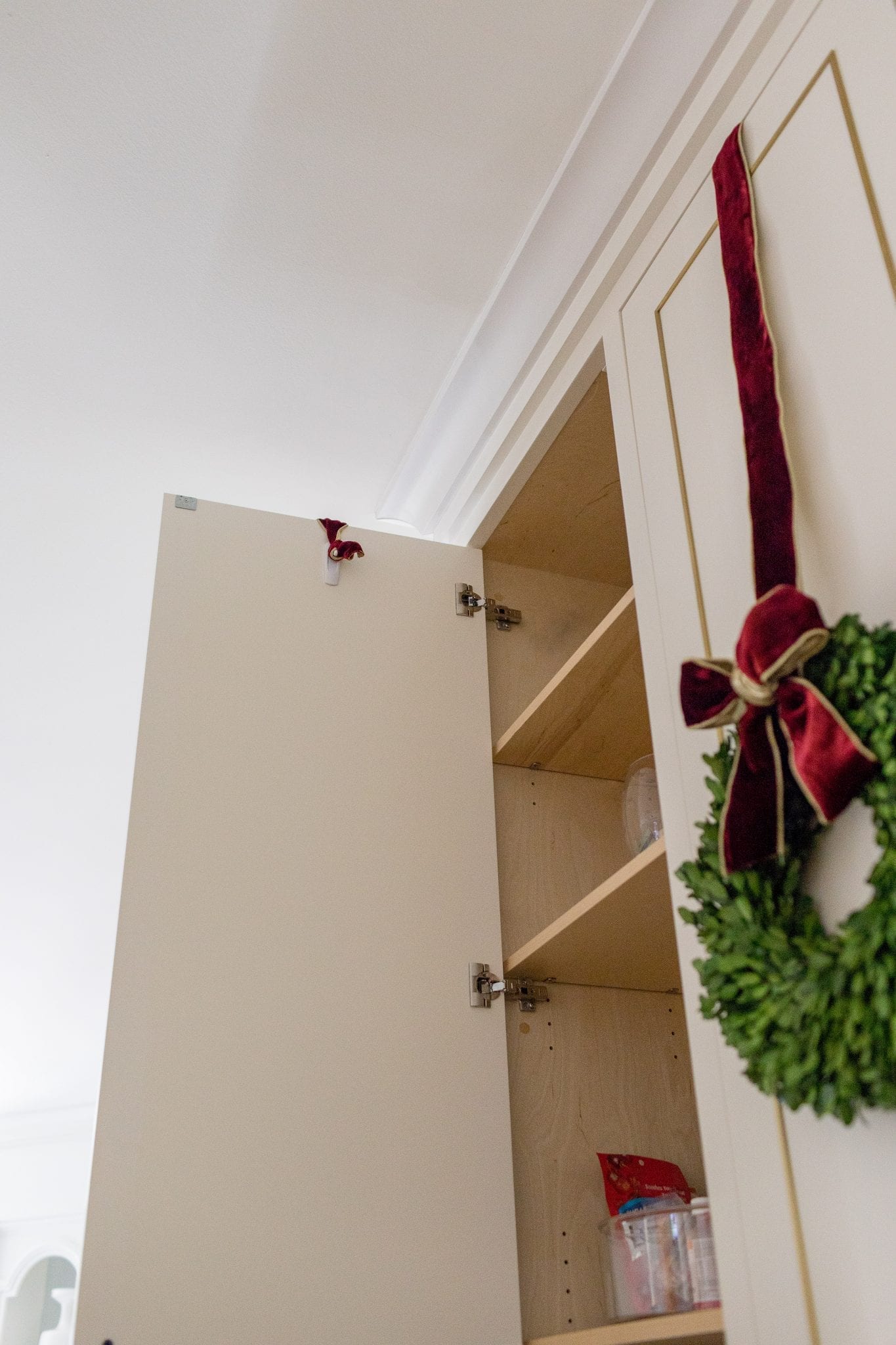 How to hang kitchen cabinet wreaths. Showing how to hang a wreath with ribbon. This method works for a big or mini wreath.