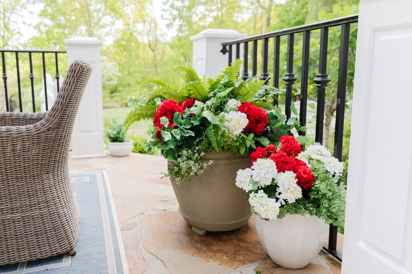 Outdoor fake flowers in artificial outdoor flower pots.