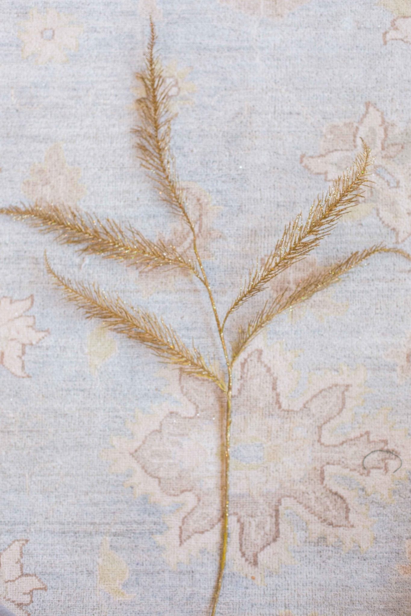 Gold Christmas Tree Spray on a blue Oushak rug.