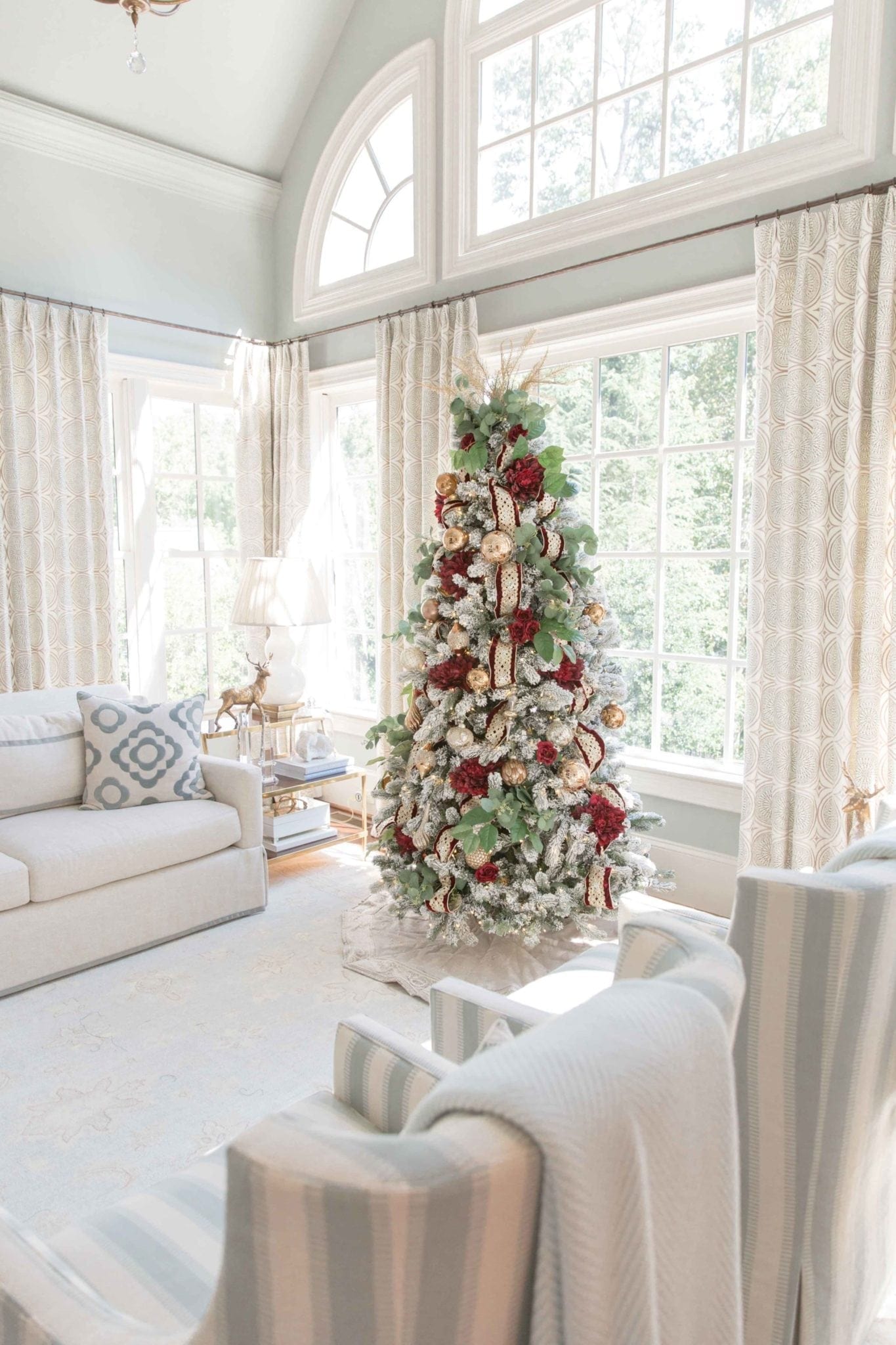 Red and gold and Green Christmas tree decorating ideas on a King of Christmas King flock with gold Christmas topper.