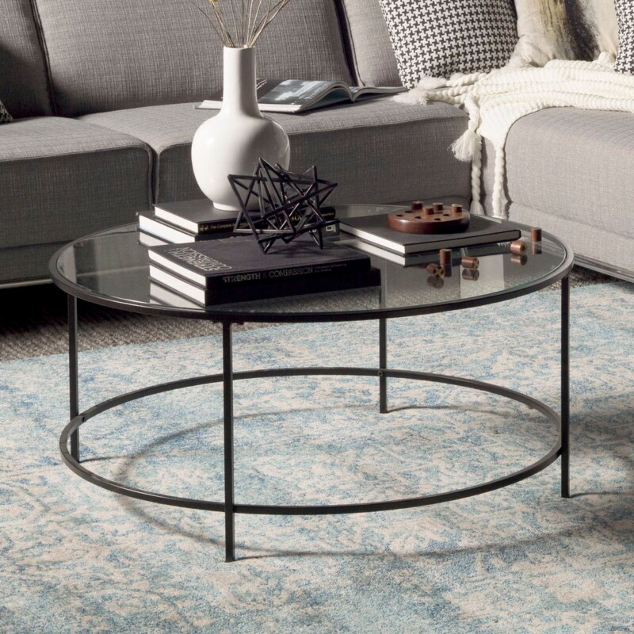 Black round coffee table with glass topper.