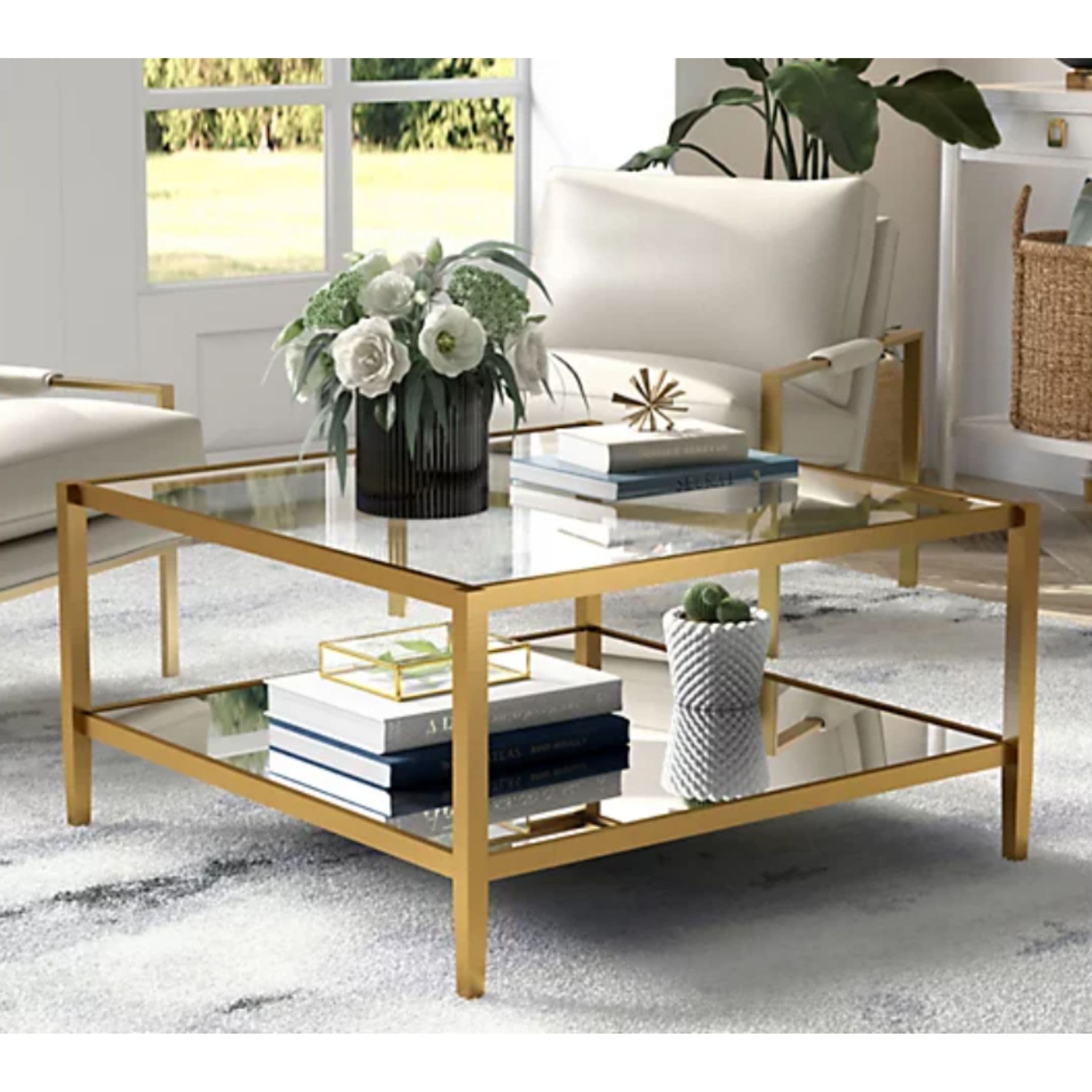 Gold coffee table with glass mirrored top and storage underneath.