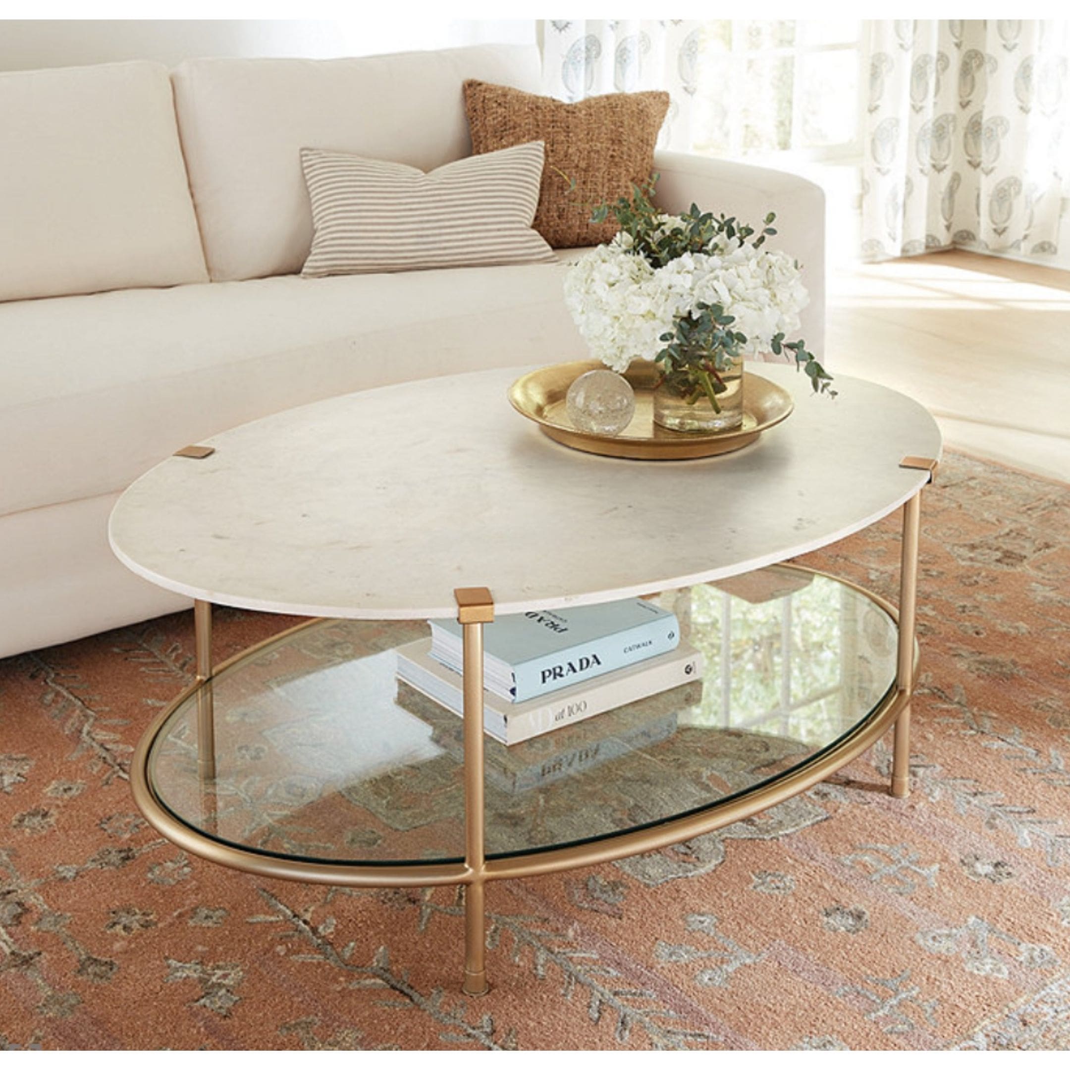 Gorgeous round marble coffee table with gold legs and storage.