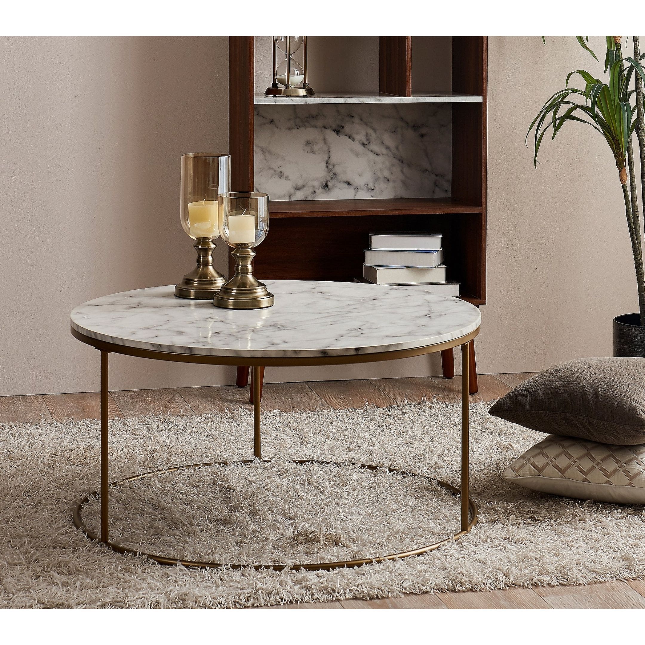 Round marble coffee table with stone top and gold legs.