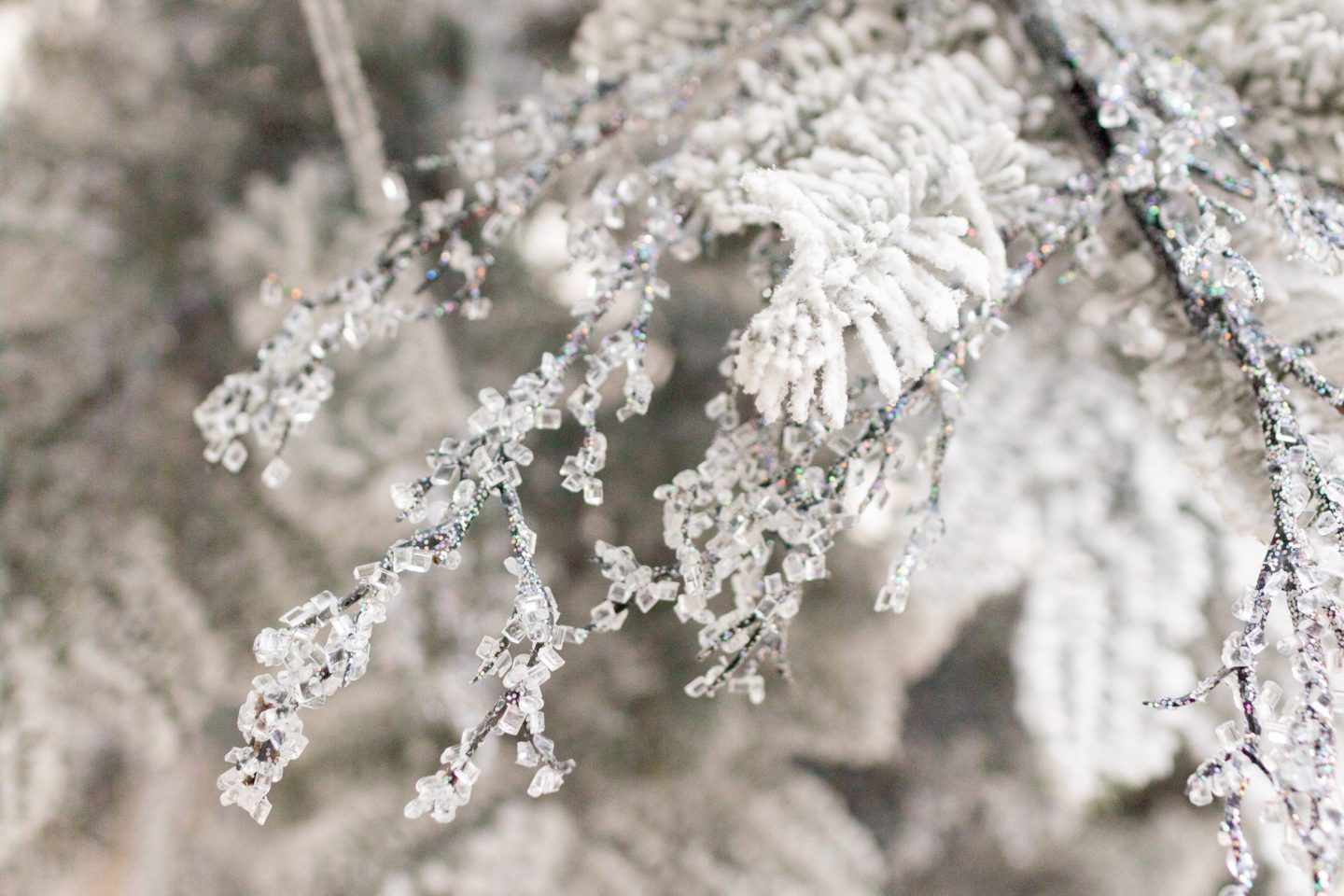Icy stems weaved through a white Christmas tree.