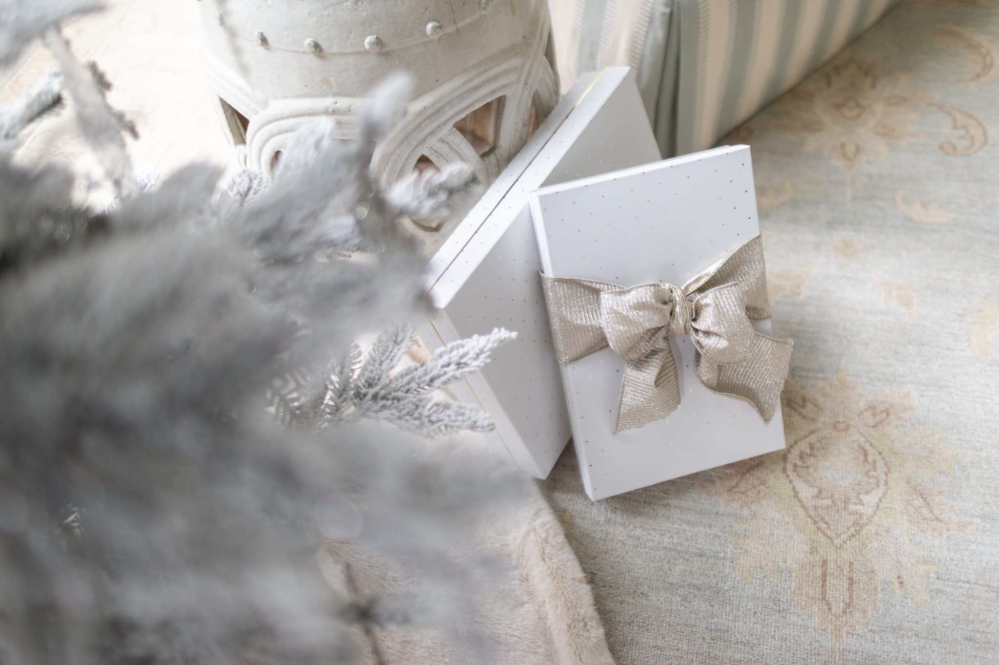 Flocked Tree with silver bow gifts underneath.