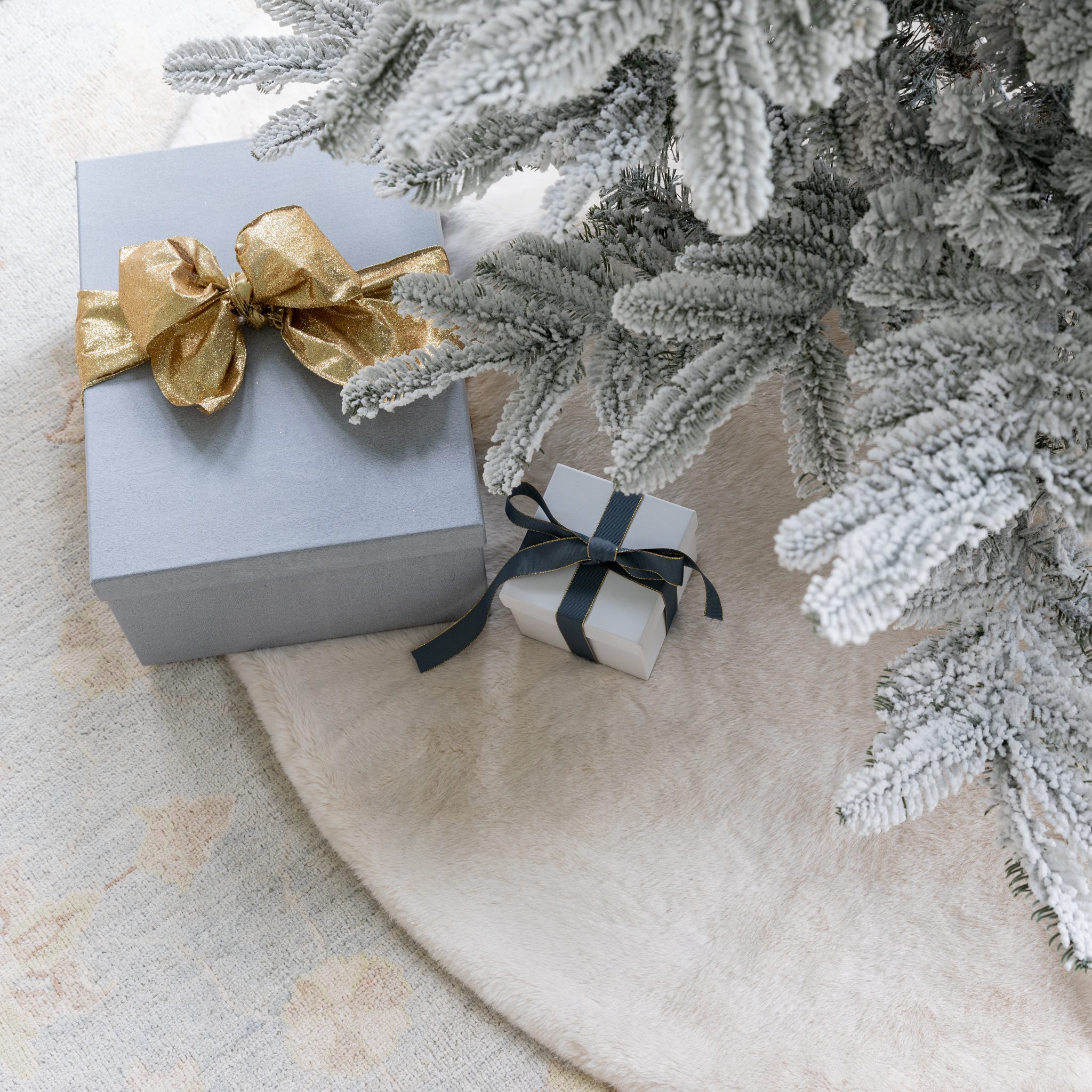 White faux fur tree skirt for a flocked and white Christmas tree