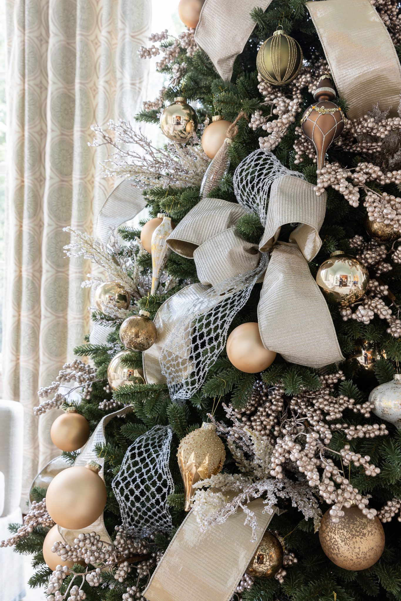 Gold ribbon layered with a mesh ribbon and gold Christmas ornaments.