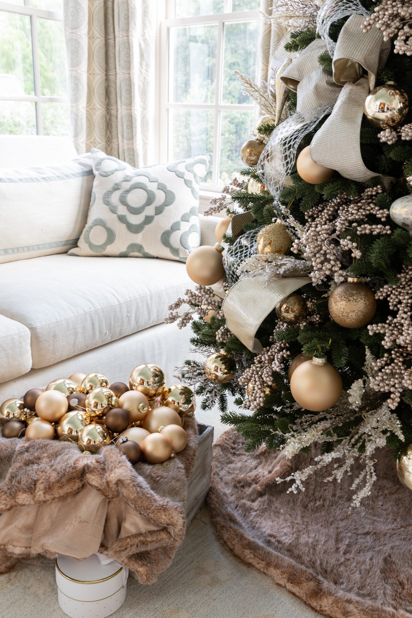 Gold themed Christmas tree with gold ornaments, ribbon and tree picks.