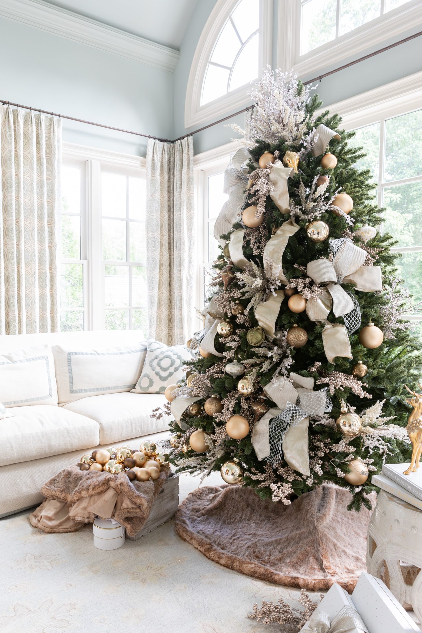 Gold decor on a green traditional tree with a homemade tree topper made of picks.