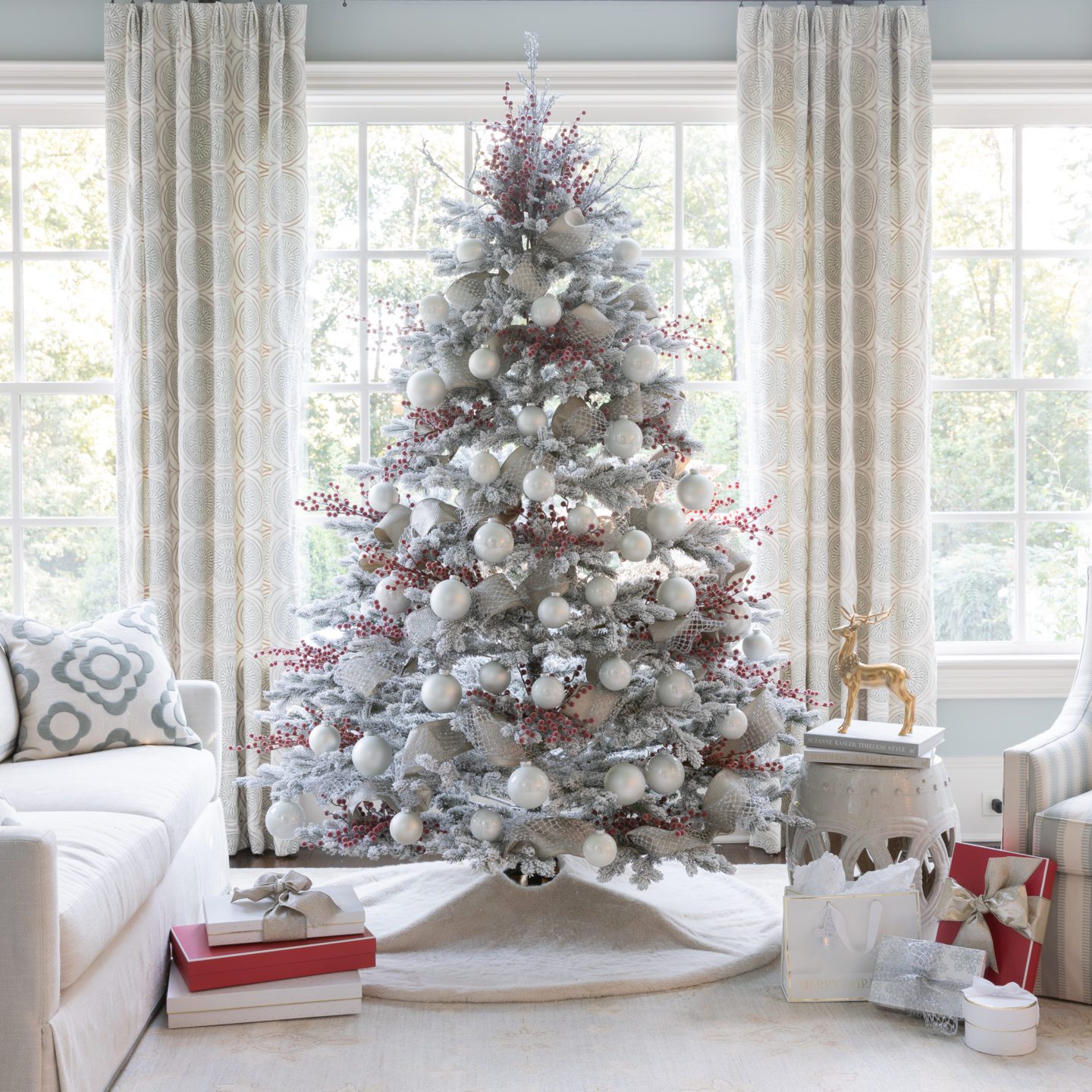 Easy way to use red berries, white ornaments, and ribbon on a flocked tree.