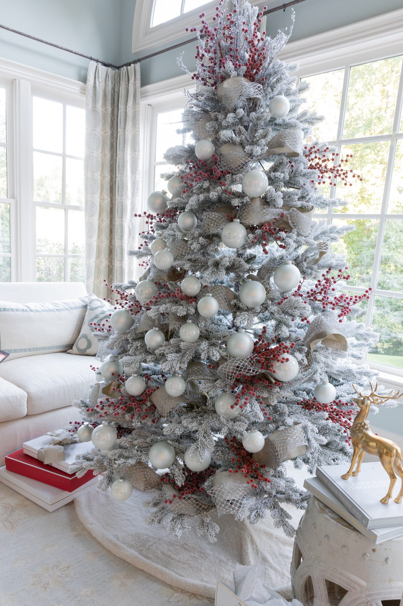 White and berry flciked tree with a DIY tree topper made with berry and silver tree picks