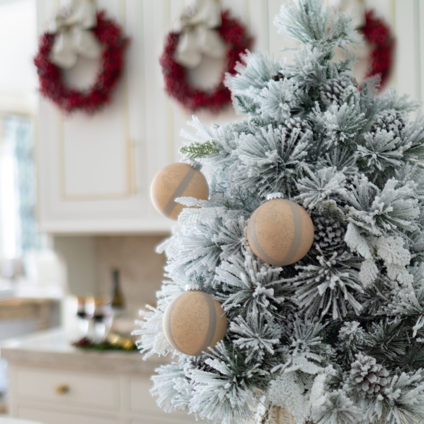 Small flocked tree in a kitchen
