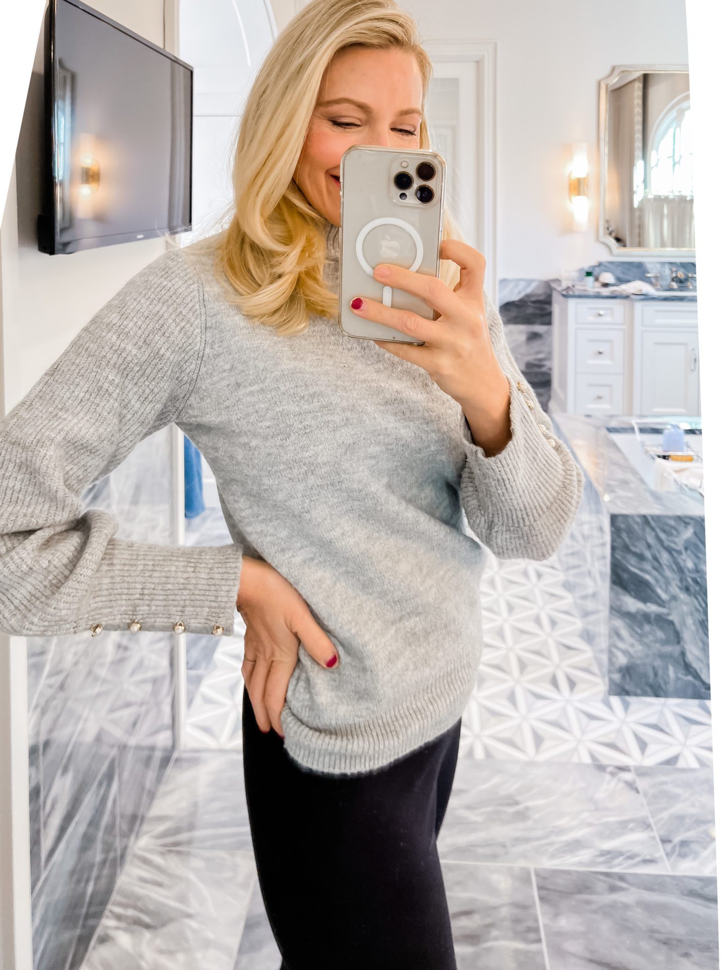 A gray womens sweater with pearls on the sleeve is worn by Atlanta lifestyle influencer Kelly Page for BlueGrayGal with black pants from Walmart.
