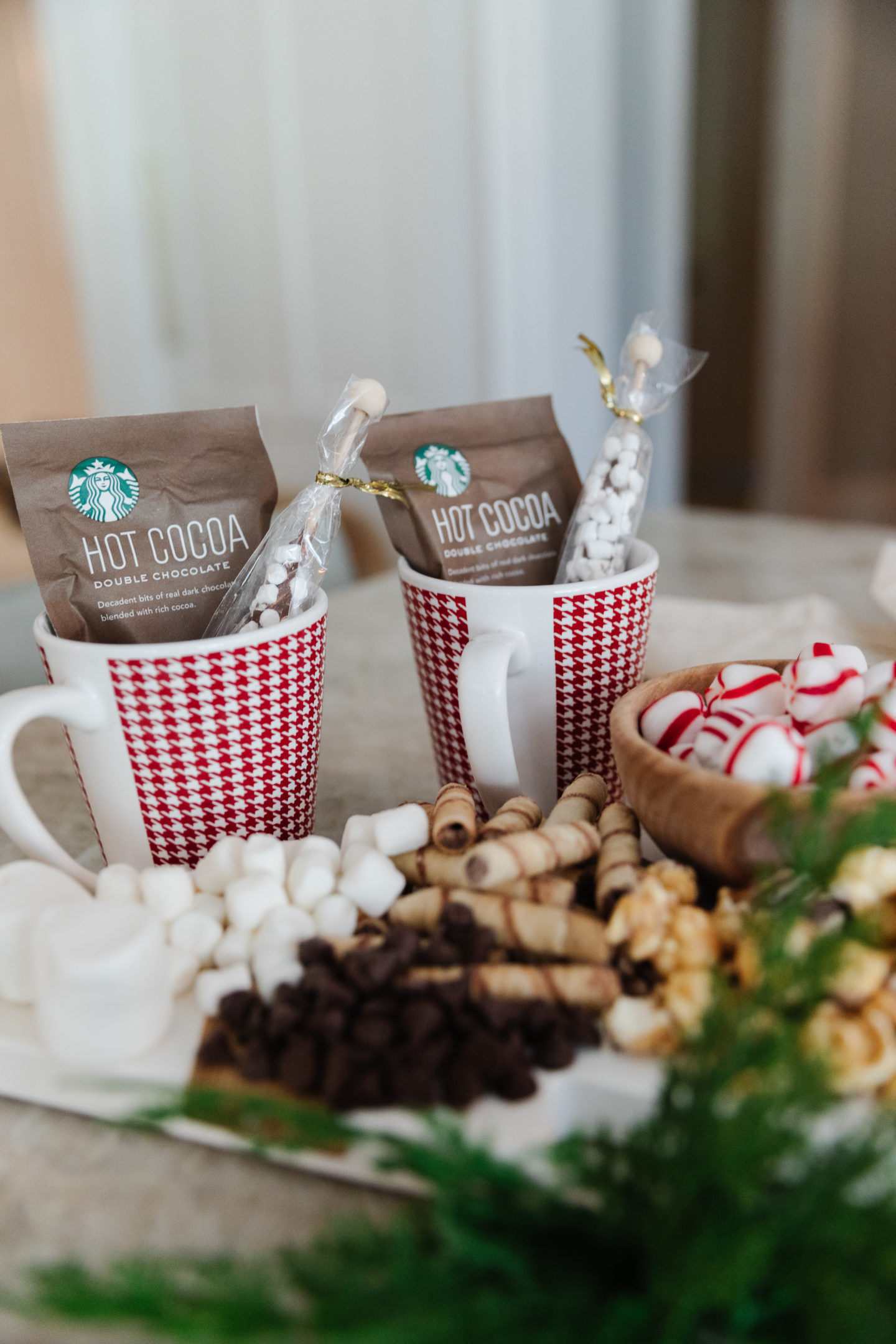 A christmas tree shaped charcuterie board covered in Christmas candy and cookies styled by holiday blogger Kelly Page for BlueGrayGal.